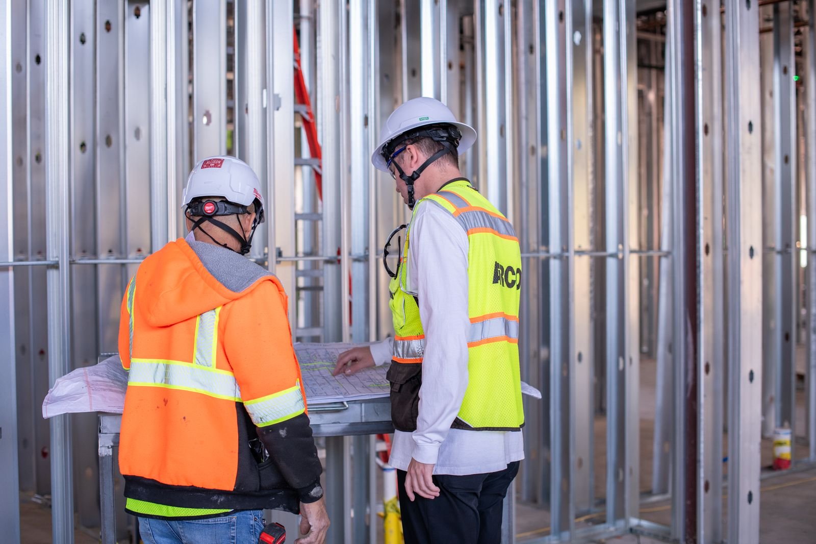 AiRCO Mechanical crew members reviewing plans on a commercial construction site
